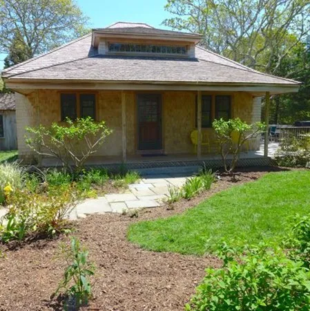 a front view of a house with garden