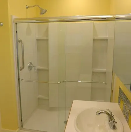a bathroom with a shower and a sink