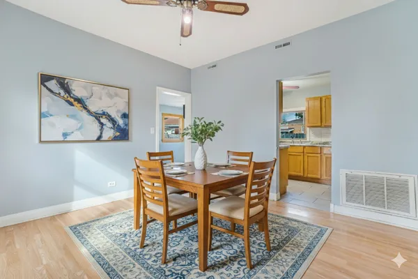 a dining room with furniture and wooden floor