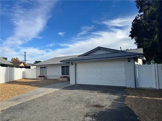 a view of the house with a yard and garage