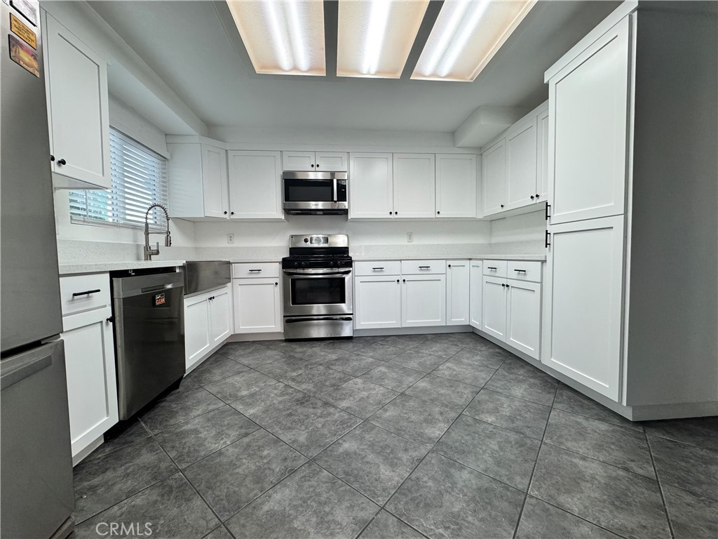 40471 Rome Beauty Way Cherry Valley, CA 92223 - Photo 11 of 32 a kitchen with stainless steel appliances granite countertop a sink and cabinets