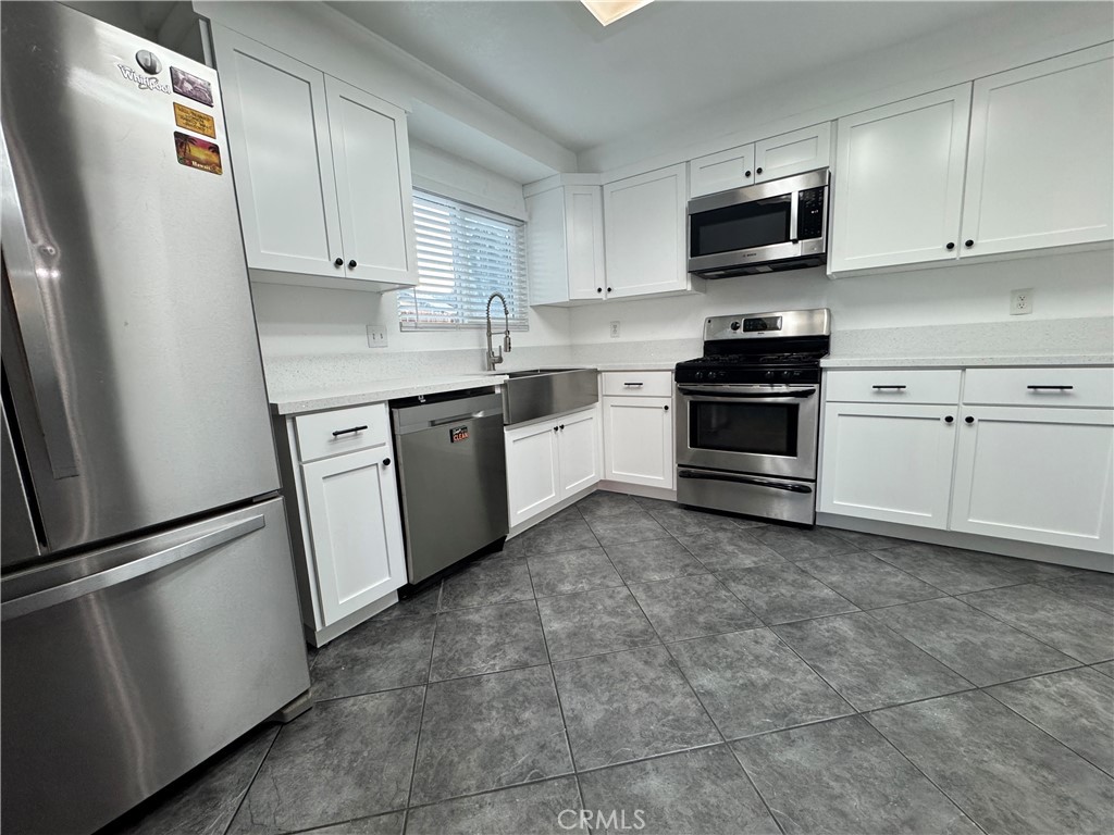 40471 Rome Beauty Way Cherry Valley, CA 92223 - Photo 12 of 32 a kitchen with granite countertop cabinets stainless steel appliances and a sink