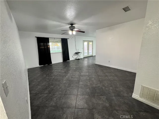 wooden floor in an empty room with a bathroom