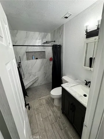 a bathroom with a shower and a toilet