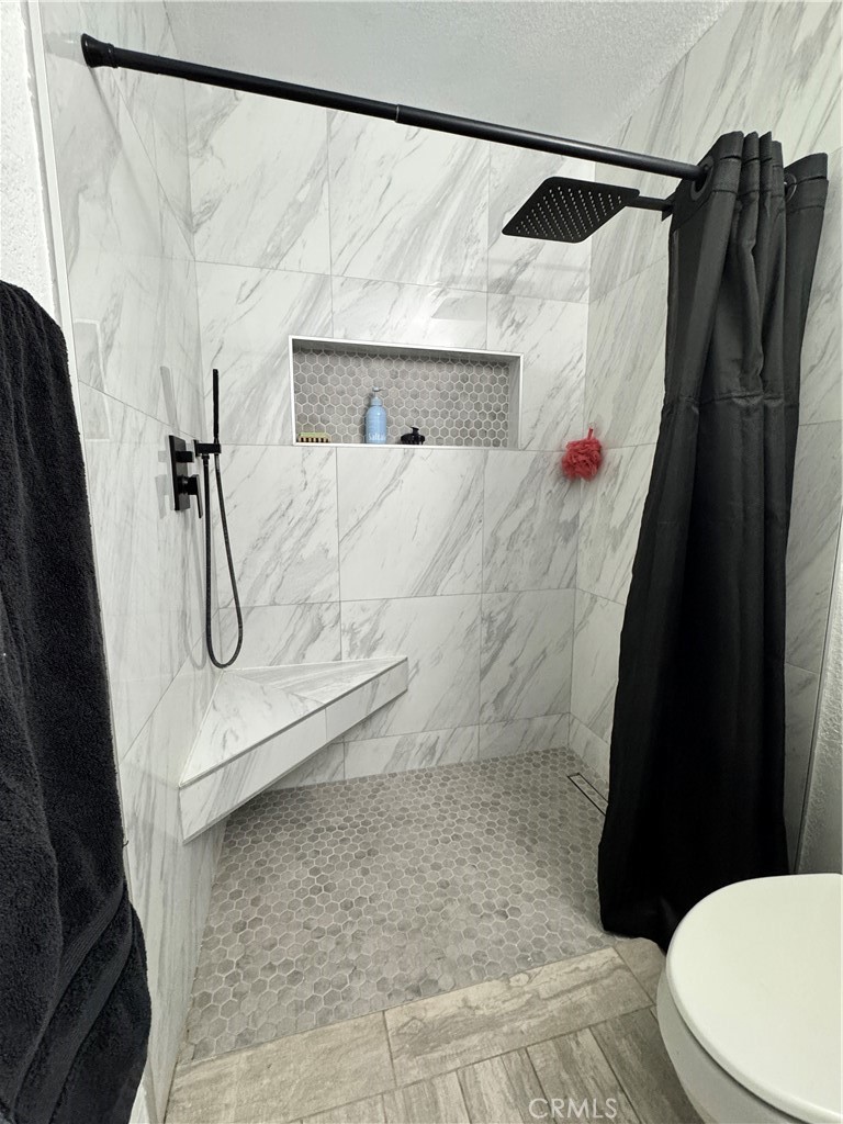 40471 Rome Beauty Way Cherry Valley, CA 92223 - Photo 16 of 32 a bathroom with a shower and a toilet