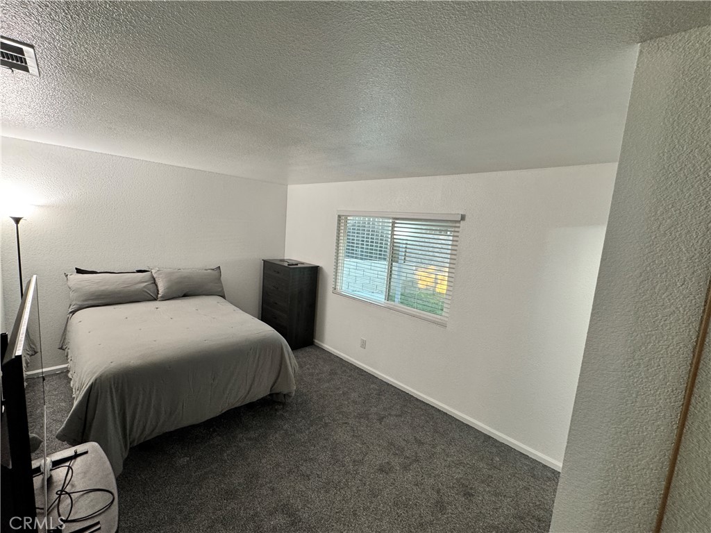 40471 Rome Beauty Way Cherry Valley, CA 92223 - Photo 17 of 32 a bedroom with bed and window
