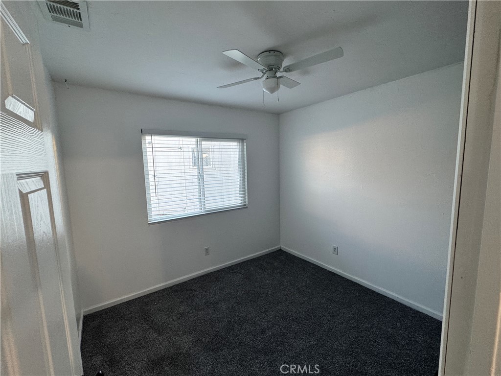 40471 Rome Beauty Way Cherry Valley, CA 92223 - Photo 20 of 32 an empty room with a window and a fan