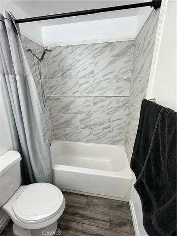 a view of a backyard with table and chairs under an umbrella