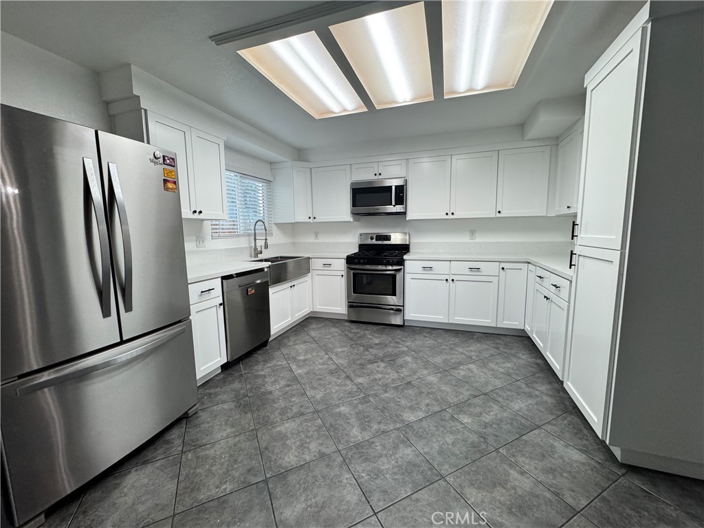 40471 Rome Beauty Way Cherry Valley, CA 92223 - Photo 6 of 32 a kitchen with stainless steel appliances granite countertop a refrigerator sink and stove