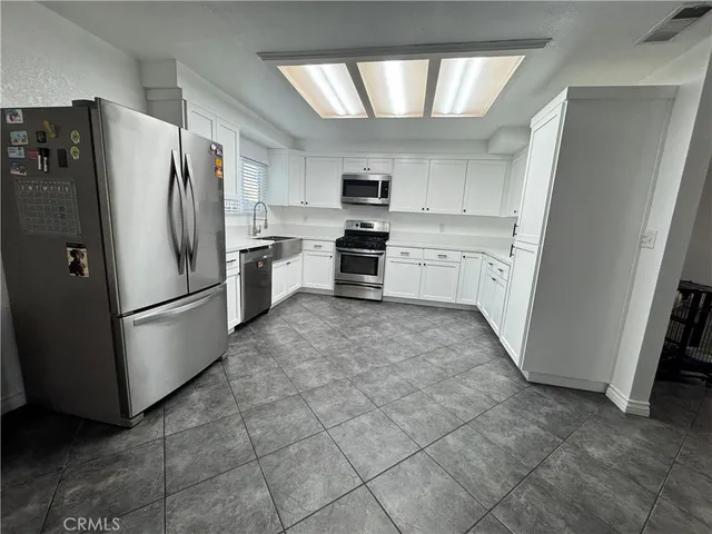 a kitchen with a sink a stove and cabinets