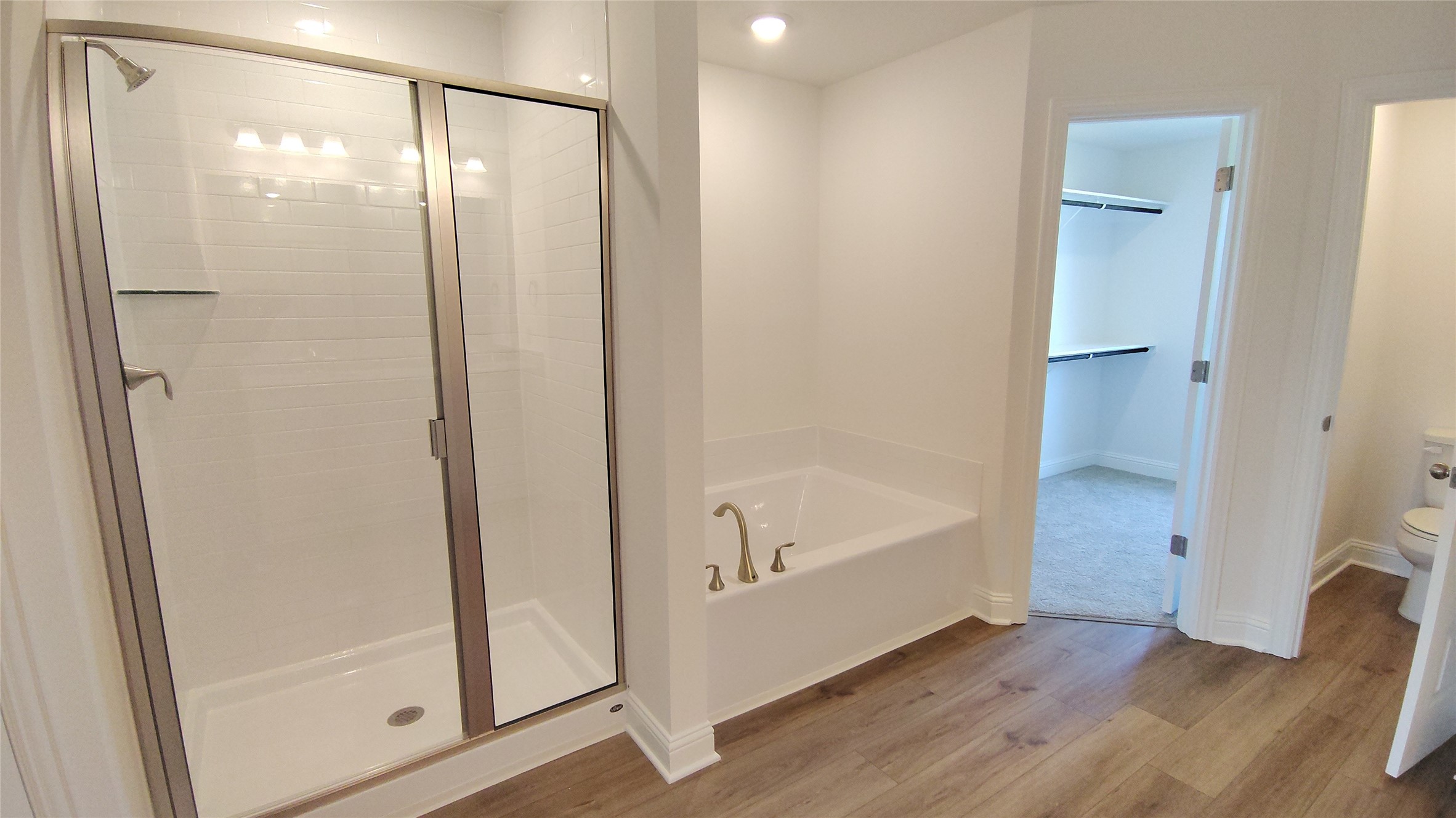 644 Greystone Lane Angleton, TX 77515 - Photo 12 of 21 a bathroom with a bathtub and a shower