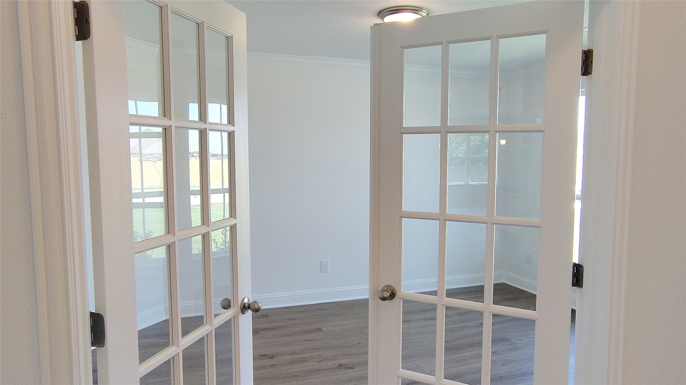 644 Greystone Lane Angleton, TX 77515 - Photo 4 of 21 a view of an empty room with wooden floor and a window