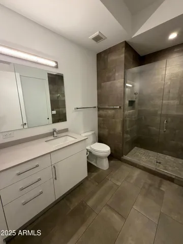 a bathroom with a toilet a sink and a mirror