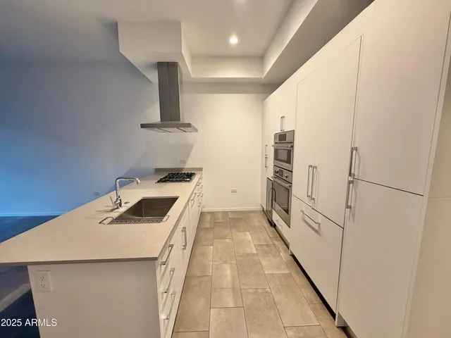 a kitchen that has a sink and a stove in it
