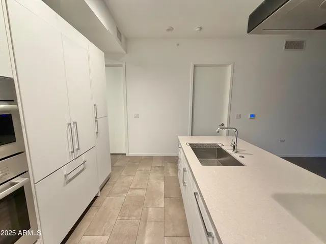 a bathroom with a sink and a large mirror