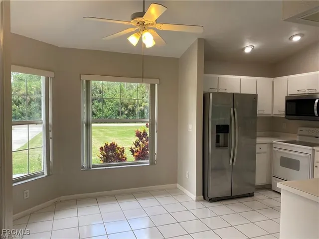 a kitchen with stainless steel appliances a refrigerator sink and microwave