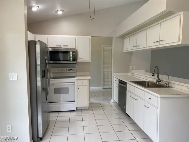 a kitchen with stainless steel appliances a stove sink and microwave