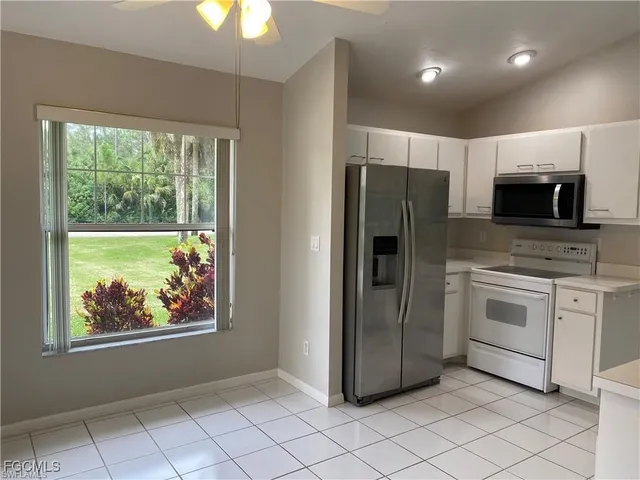 a kitchen with stainless steel appliances a refrigerator sink and microwave