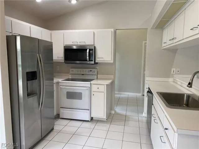 a kitchen with a refrigerator sink and microwave