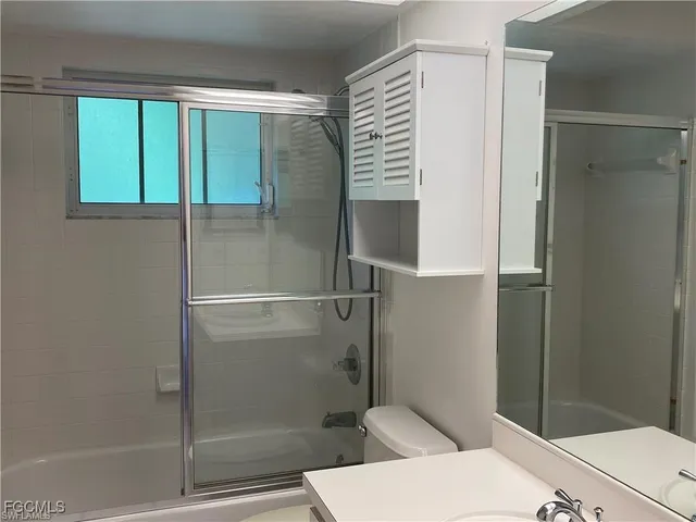 a bathroom with a shower and a toilet