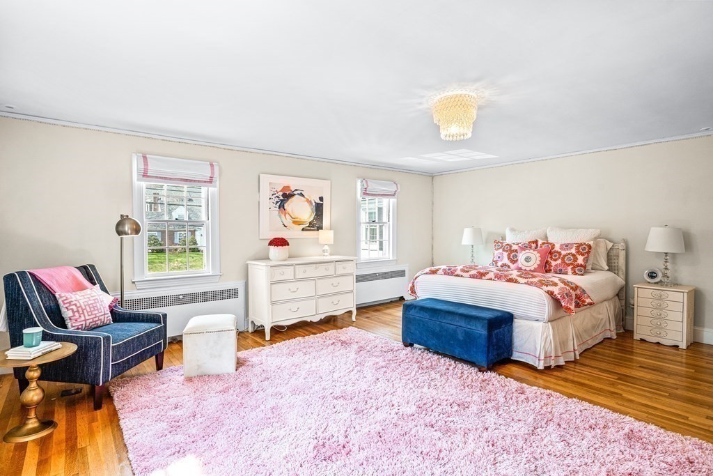 642 Centre Street Newton, MA 02458 - Photo 16 of 26 a bedroom with a bed and wooden floor