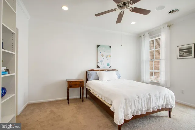 a bedroom with a bed and window