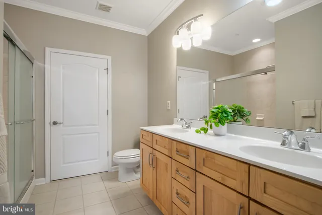 a spacious bathroom with a granite countertop sink mirror and toilet
