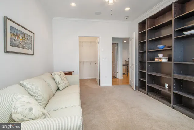 a living room with furniture and a view of kitchen