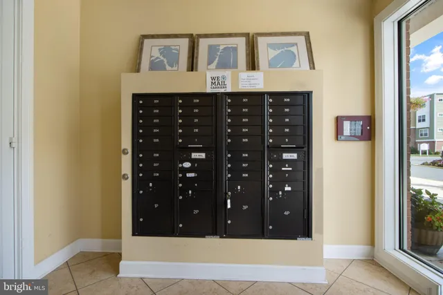 a view of a hallway with wooden floor and cabinet