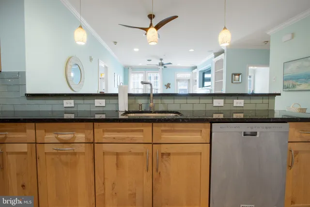 a kitchen with stainless steel appliances granite countertop a sink a stove and a wooden floors