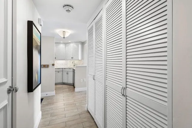 a kitchen with white cabinets and white appliances