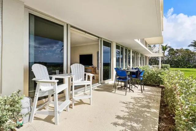 a view of a patio with table and chairs and potted plants