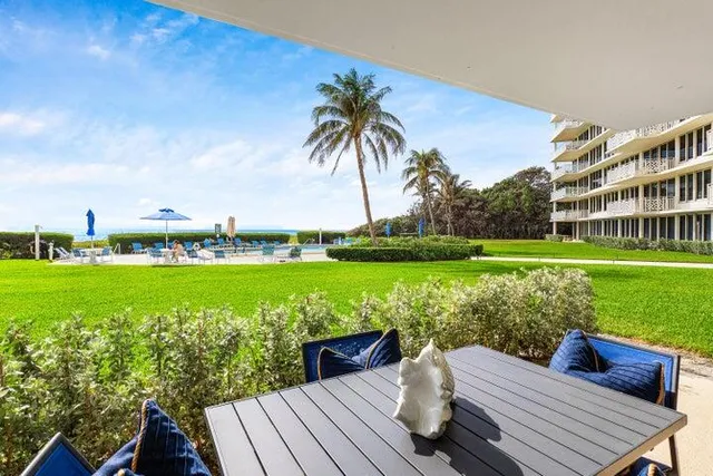 a view of a deck with chairs and a yard
