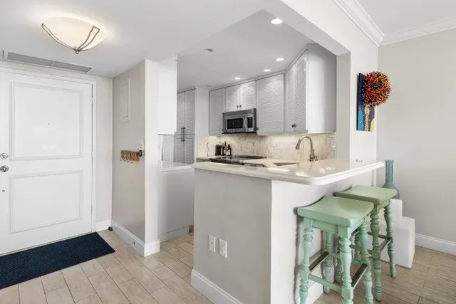 a kitchen with a sink cabinets and wooden floor