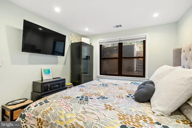 a bedroom with a bed and a flat screen tv