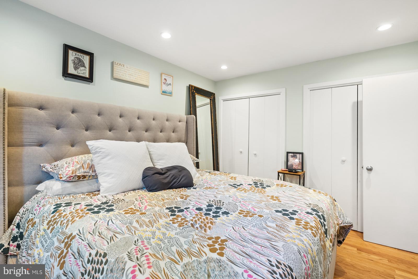 1710 Summit Place Northwest, Unit 1710 Washington, DC 20009 - Photo 16 of 35 a bedroom with a large bed and a lamp