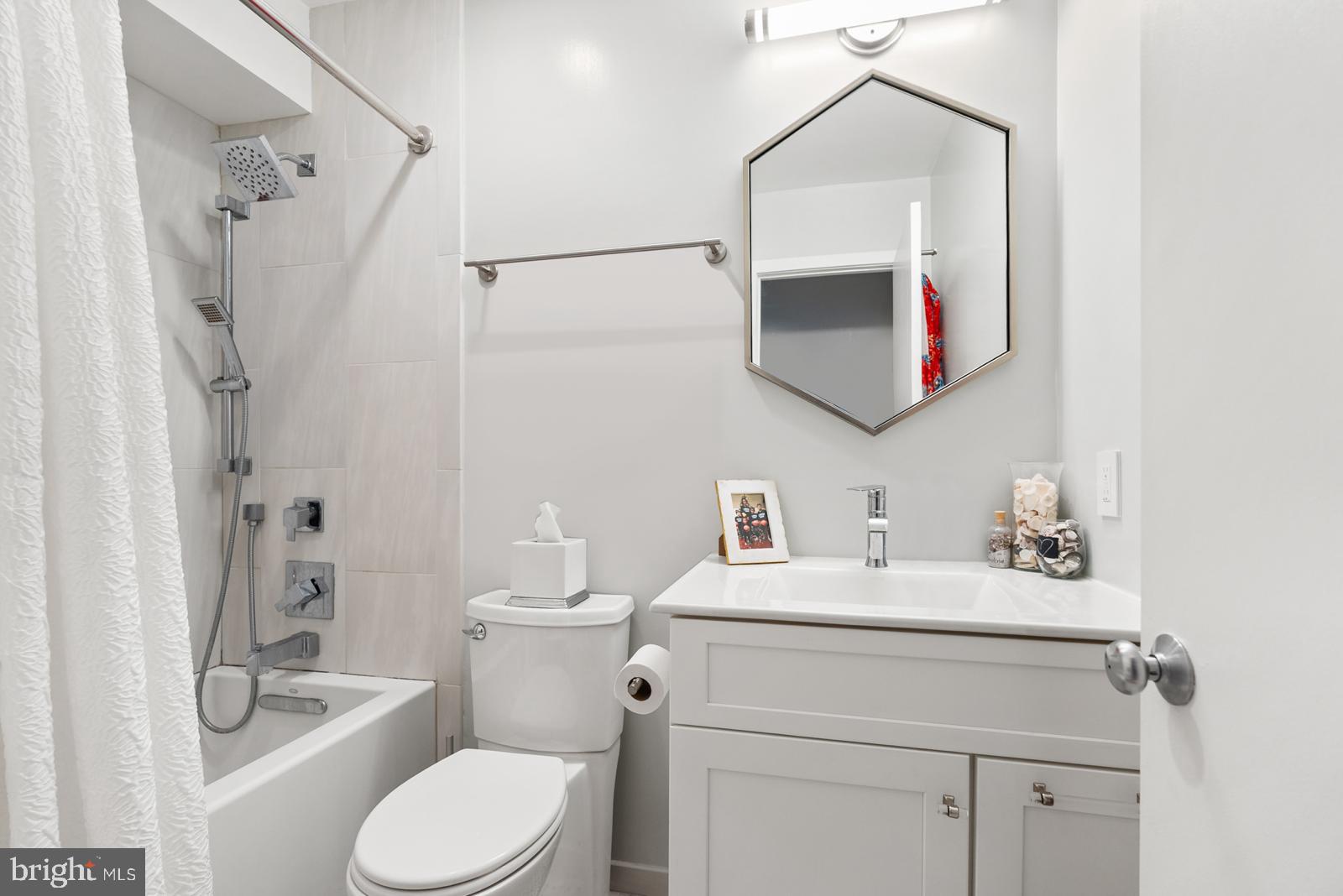 1710 Summit Place Northwest, Unit 1710 Washington, DC 20009 - Photo 17 of 35 a bathroom with a sink vanity mirror and toilet