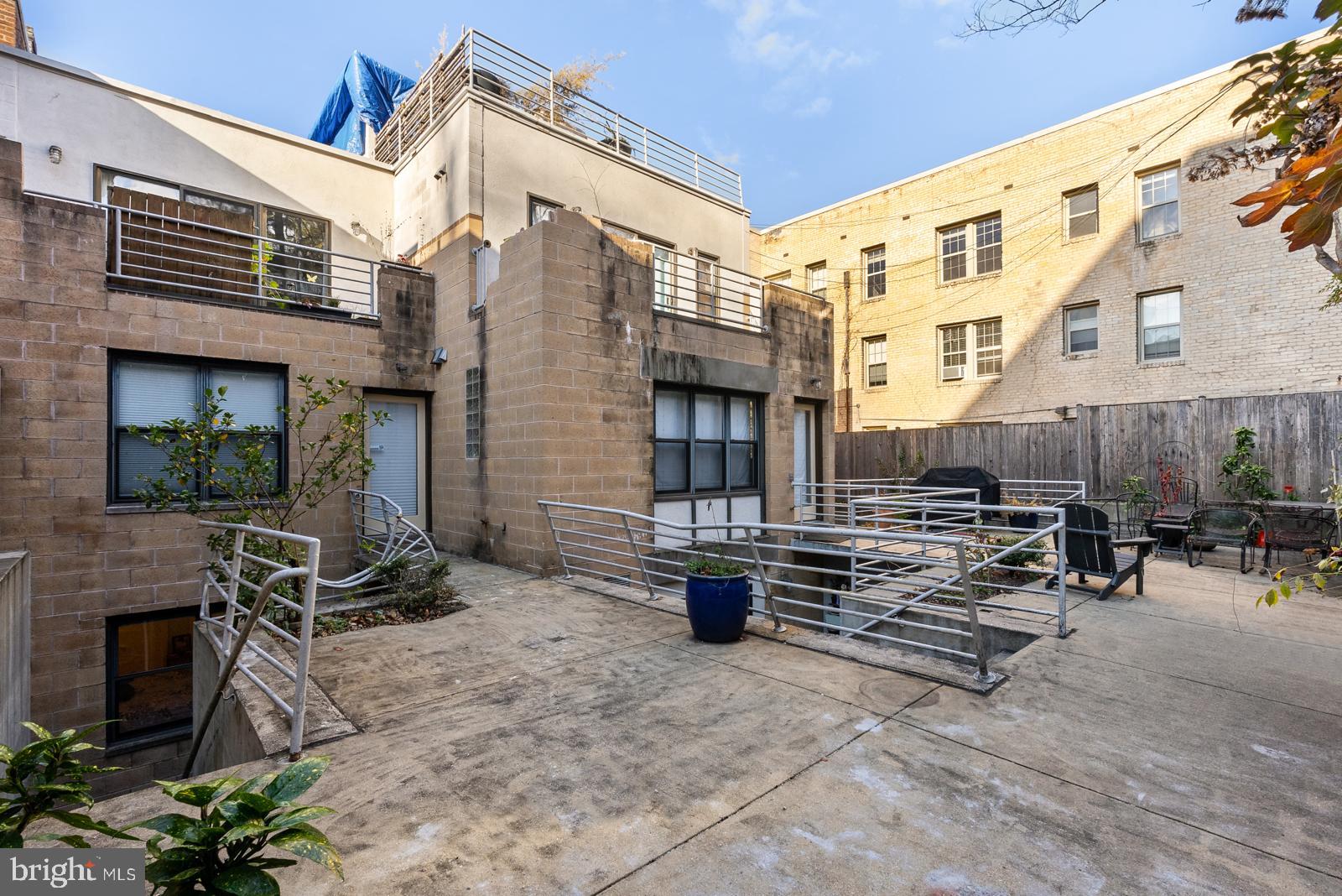 1710 Summit Place Northwest, Unit 1710 Washington, DC 20009 - Photo 32 of 35 a view of a chairs with barbeque in the patio