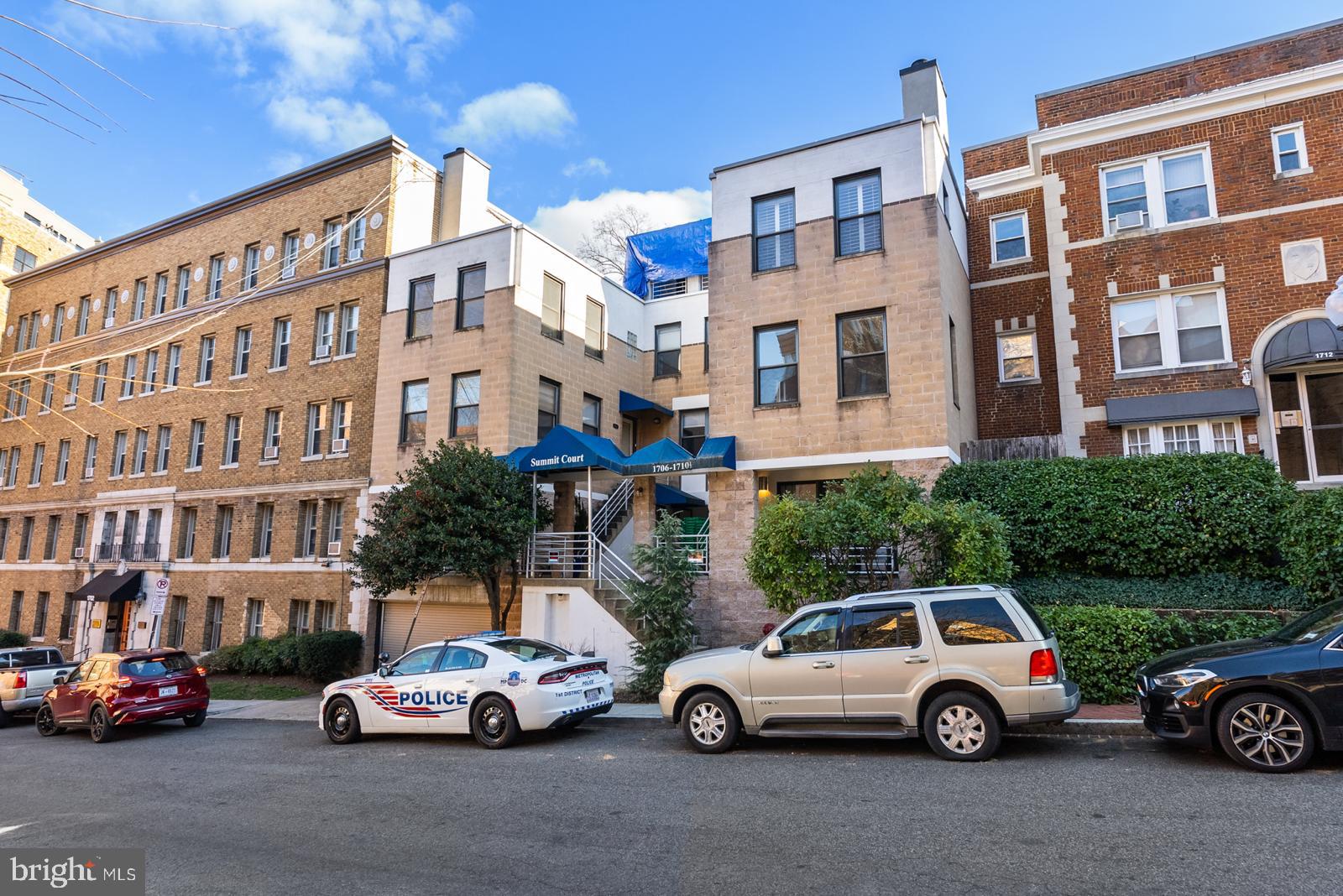 1710 Summit Place Northwest, Unit 1710 Washington, DC 20009 - Photo 35 of 35 a view of cars parked in front of a building