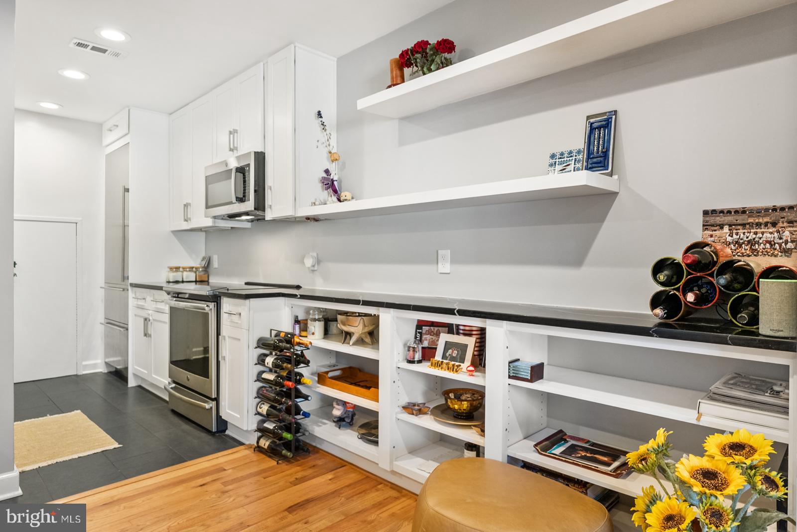 1710 Summit Place Northwest, Unit 1710 Washington, DC 20009 - Photo 6 of 35 a kitchen with stainless steel appliances granite countertop a refrigerator and a stove top oven