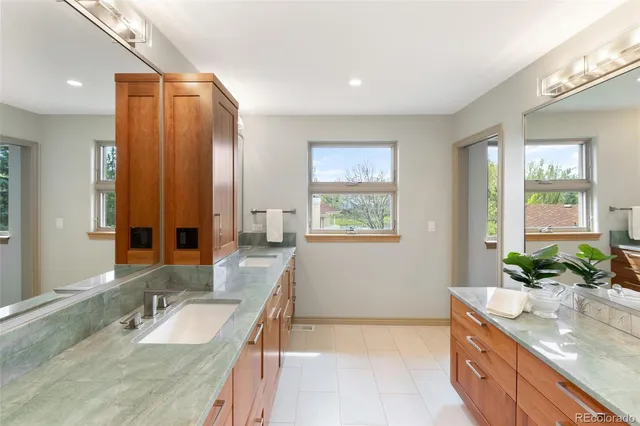 a bathroom with a granite countertop sink and a mirror