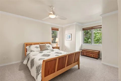 a bedroom with a bed and a table in it with window