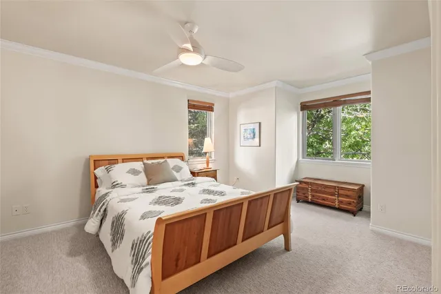 a bedroom with a bed and a table in it with window