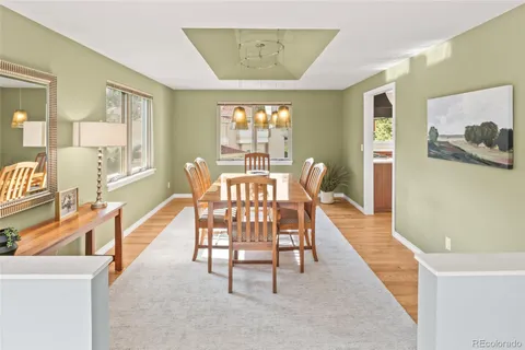 a view of a dining room with furniture wooden floor and chandelier