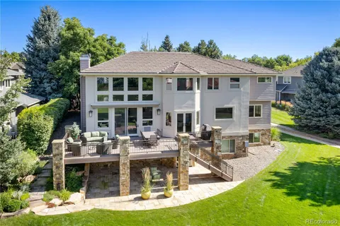 a view of a lush green field with mountains in the background