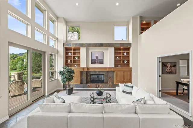 a living room with stainless steel appliances kitchen island granite countertop furniture and a view of kitchen