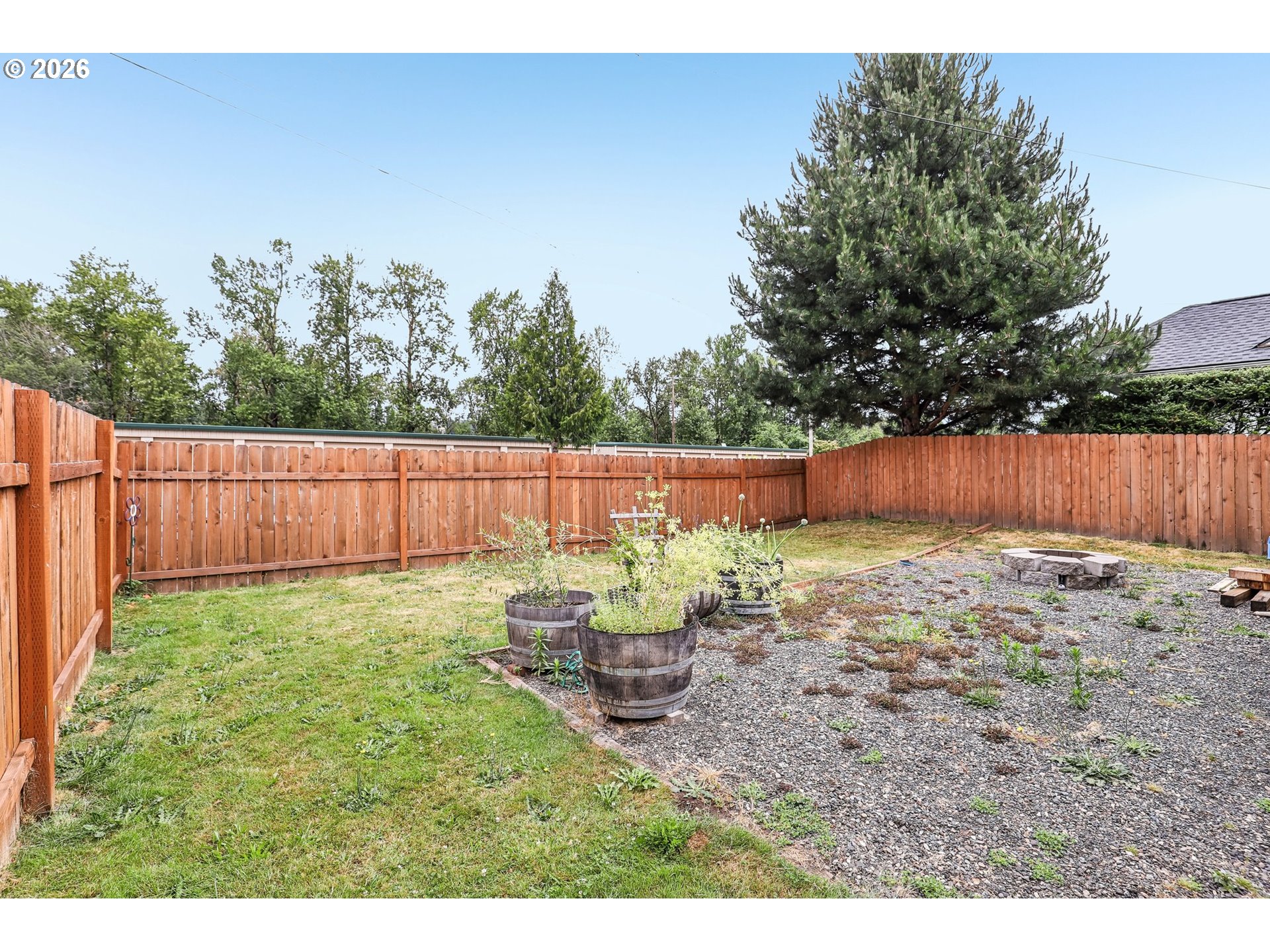 608 Southeast Sumner Street Camas, WA 98607 - Photo 29 of 39 a view of a backyard with wooden fence