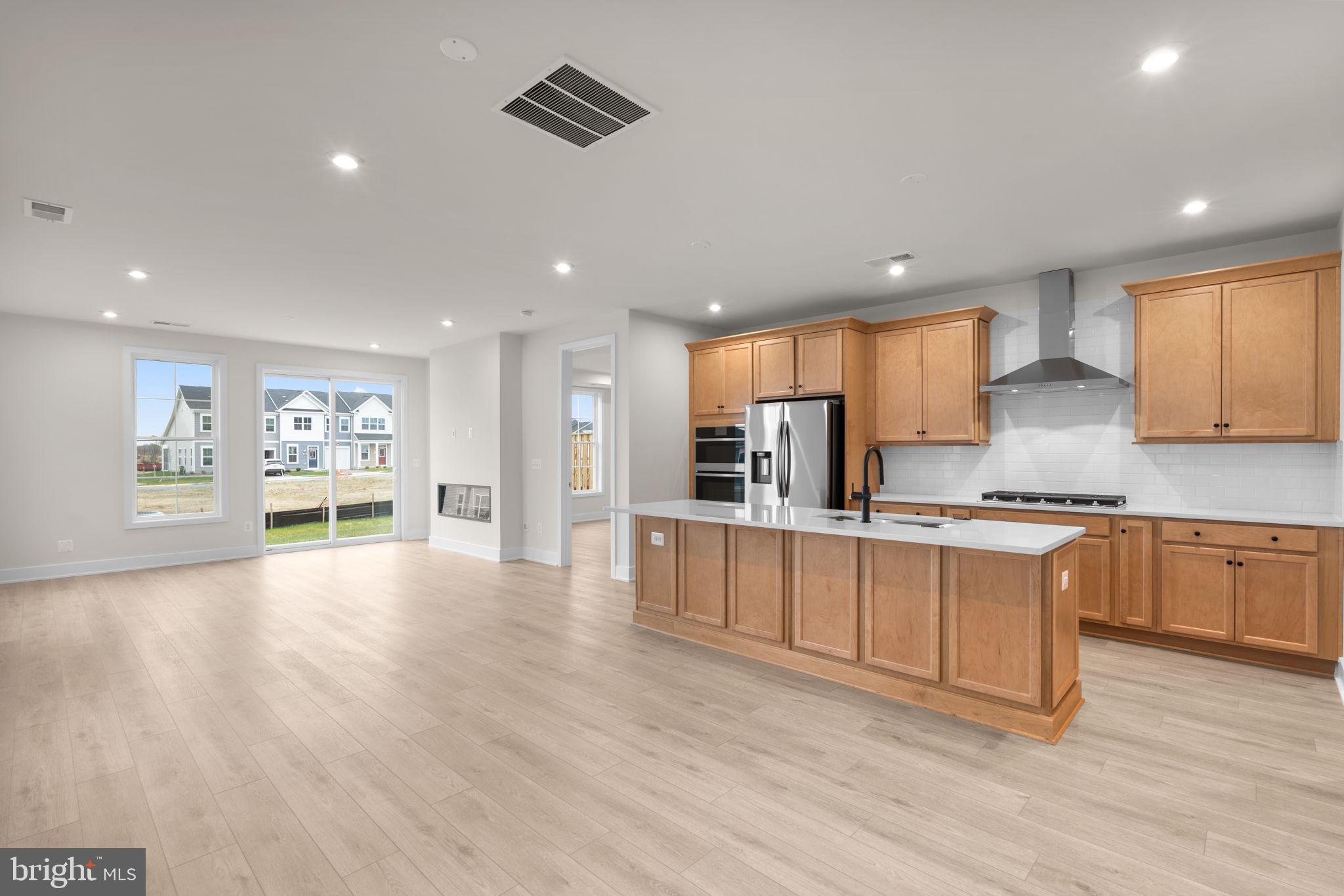 108 Keystone Winchester, VA 22603 - Photo 17 of 46 a large kitchen with stainless steel appliances granite countertop a lot of counter space and wooden floor