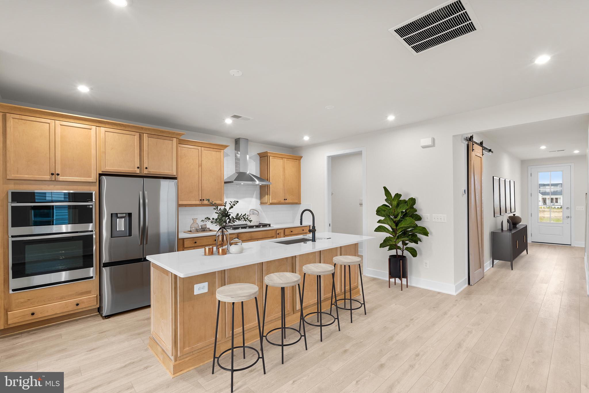 108 Keystone Winchester, VA 22603 - Photo 3 of 46 a kitchen with granite countertop a refrigerator oven a sink a dining table and chairs with wooden floor