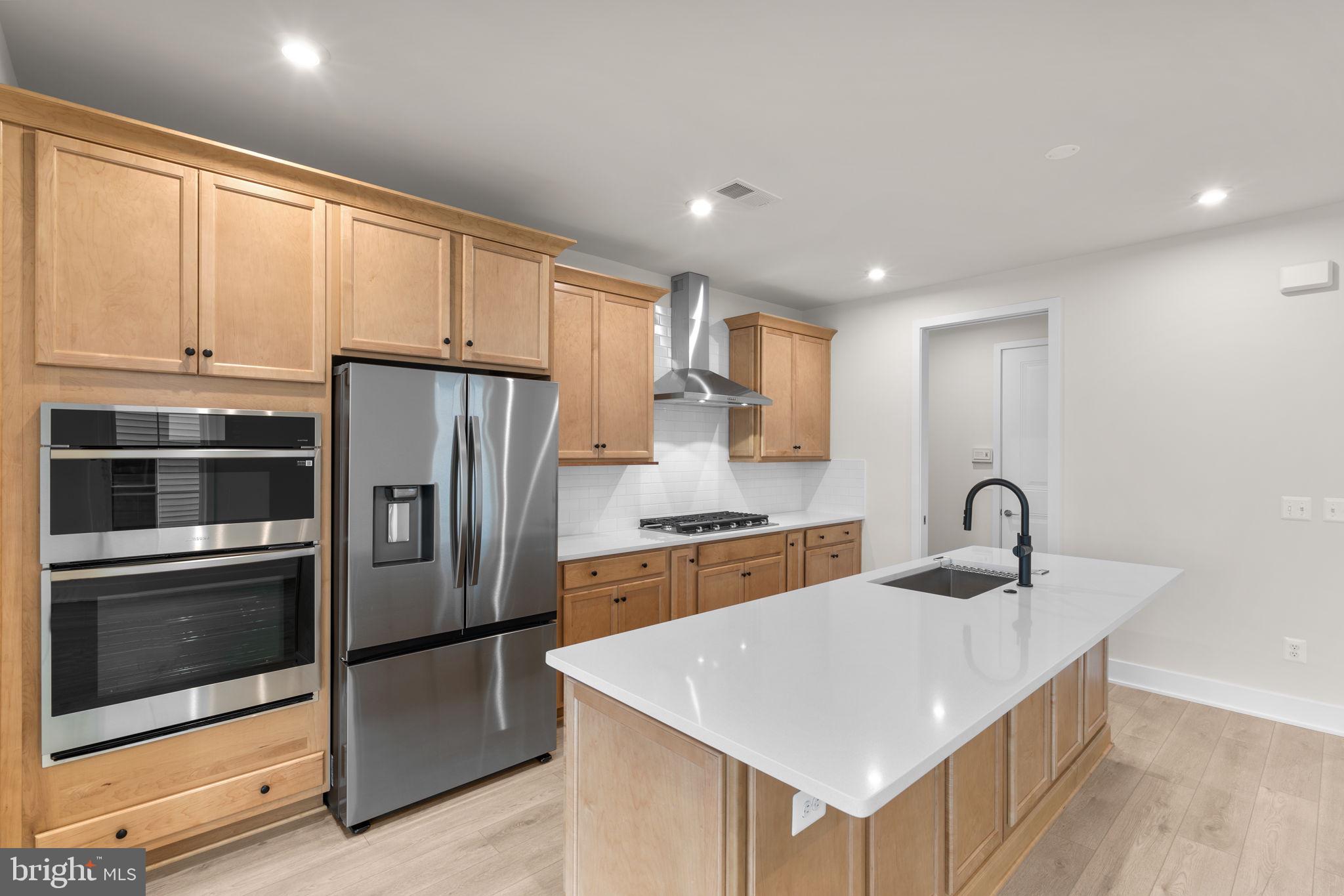 108 Keystone Winchester, VA 22603 - Photo 9 of 46 a kitchen with kitchen island granite countertop a stove sink and refrigerator
